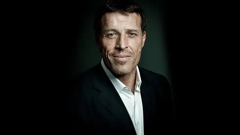 Tony Robbins passionately speaking on stage, inspiring personal growth and success.